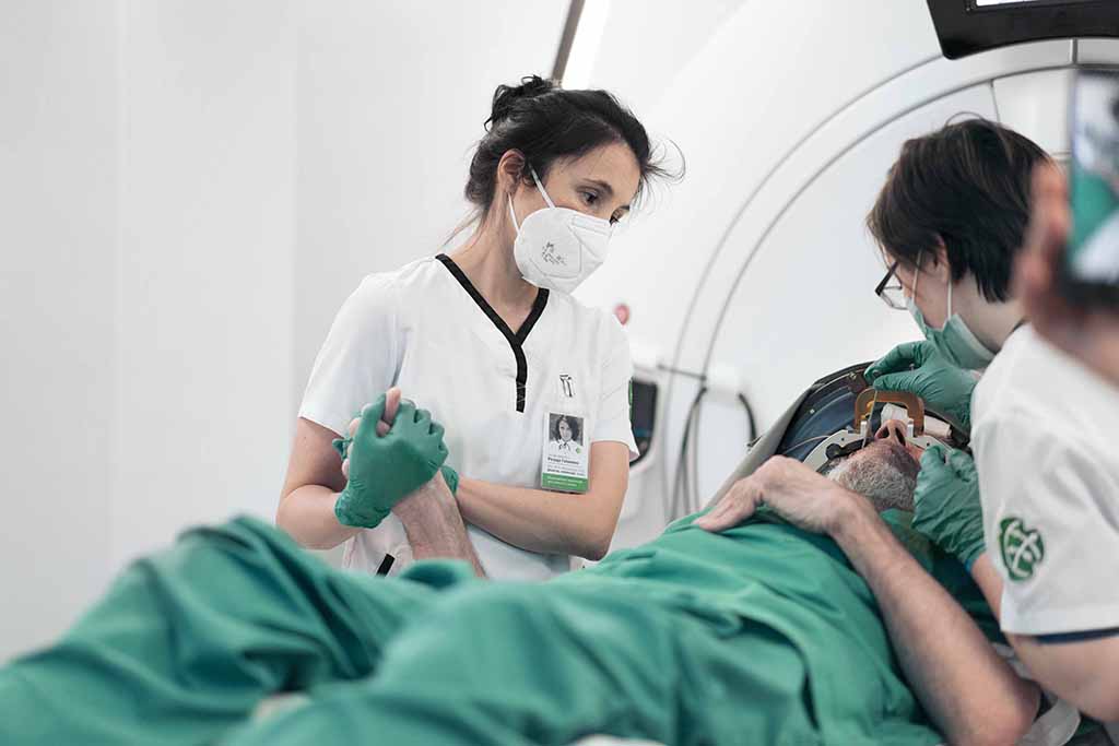 Rezida Galimova holds the patient's hand during focused ultrasound treatment for tremor Rezida Galimova holds the patient's hand during focused ultrasound treatment of tremor